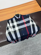 Long-sleeve plaid shirt on hanger, navy, white, and red check with button front