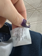 Clothing care label inside coat showing fabric percentages and country info
