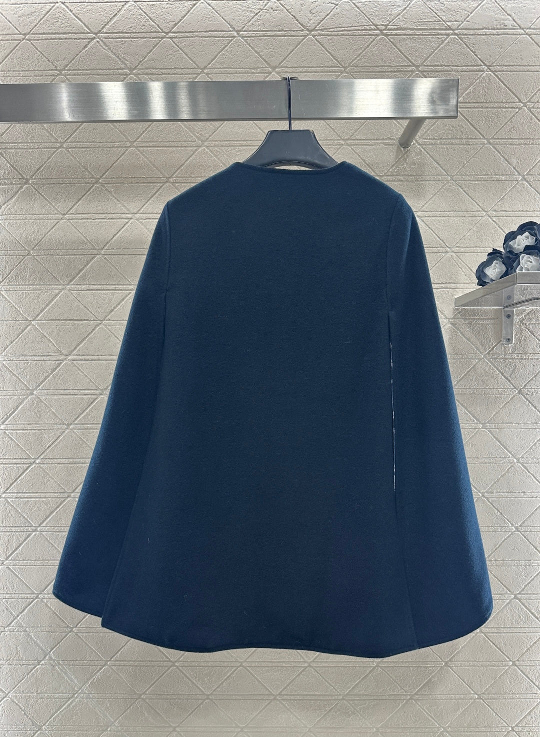 Navy long coat, back view with clean yoke seam and flared silhouette