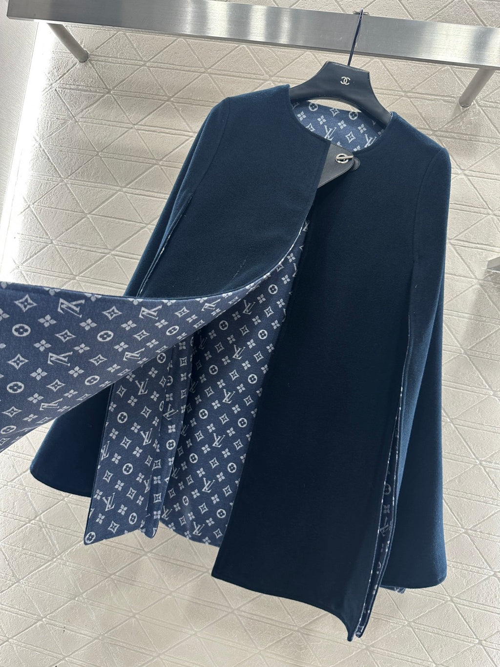 Navy long coat with monogram patterned lining at collar and front placket