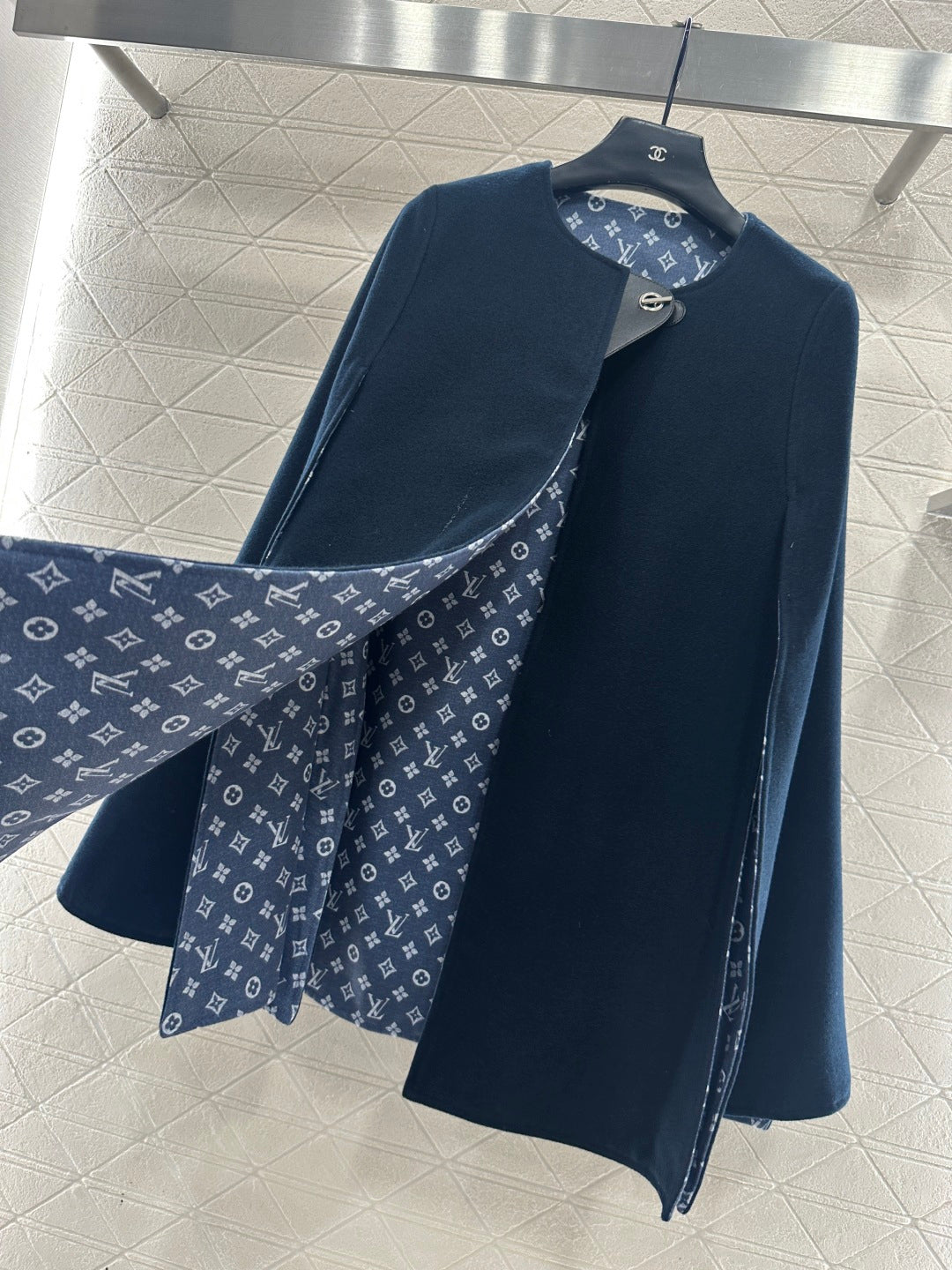 Navy long coat with monogram patterned lining at collar and front placket