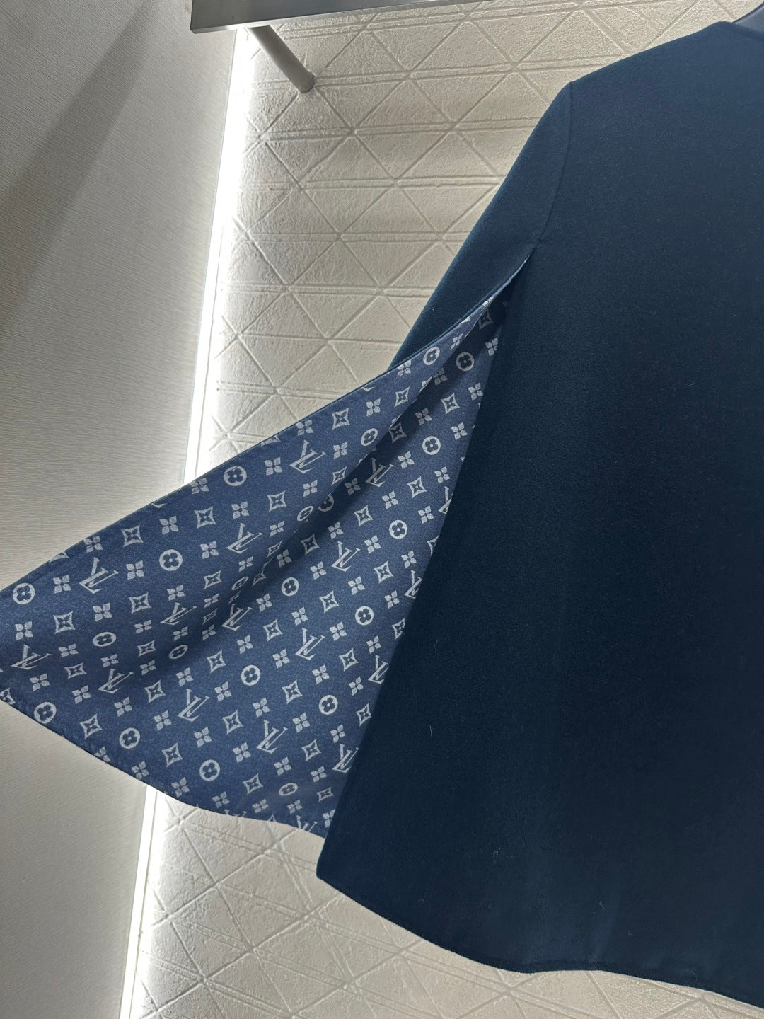 Navy long coat with monogram patterned inner collar and placket lining