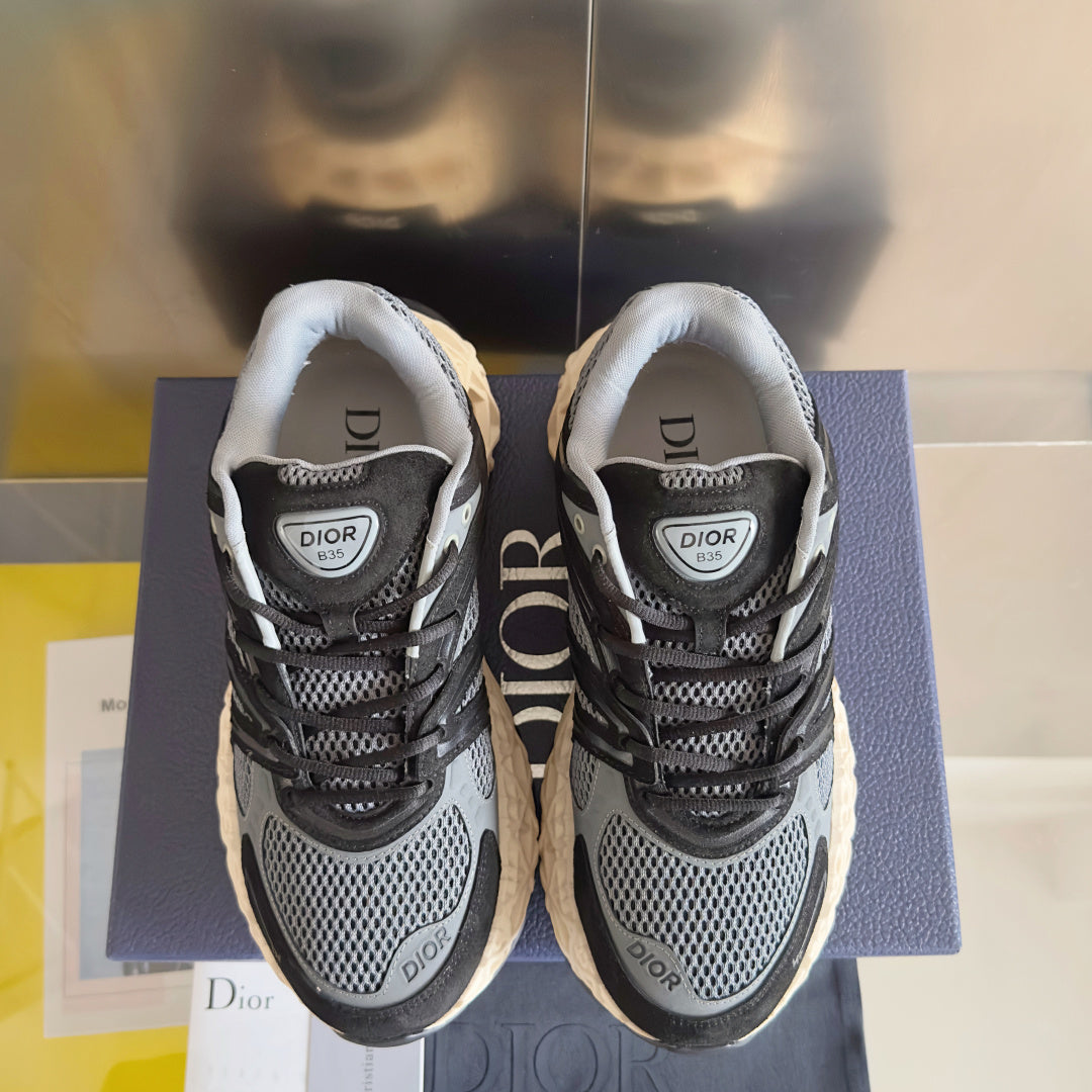 Dior unisex sneakers front view, dark gray mesh with black laces and cream sole