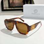 Tortoise-shell cat-eye sunglasses with amber lenses and gold logo plaque