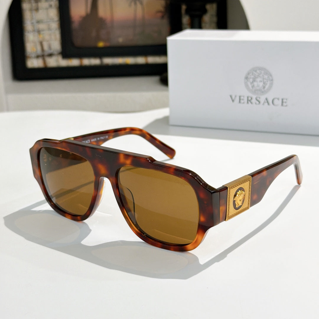 Tortoise-shell cat-eye sunglasses with amber lenses and gold logo plaque