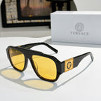 Black cat-eye sunglasses with yellow reflective lenses and gold logo plaque