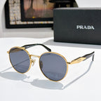 Prada sunglasses with gold metal round frames and blue tinted lenses