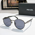 Prada sunglasses with silver metal round frames and dark blue tinted lenses