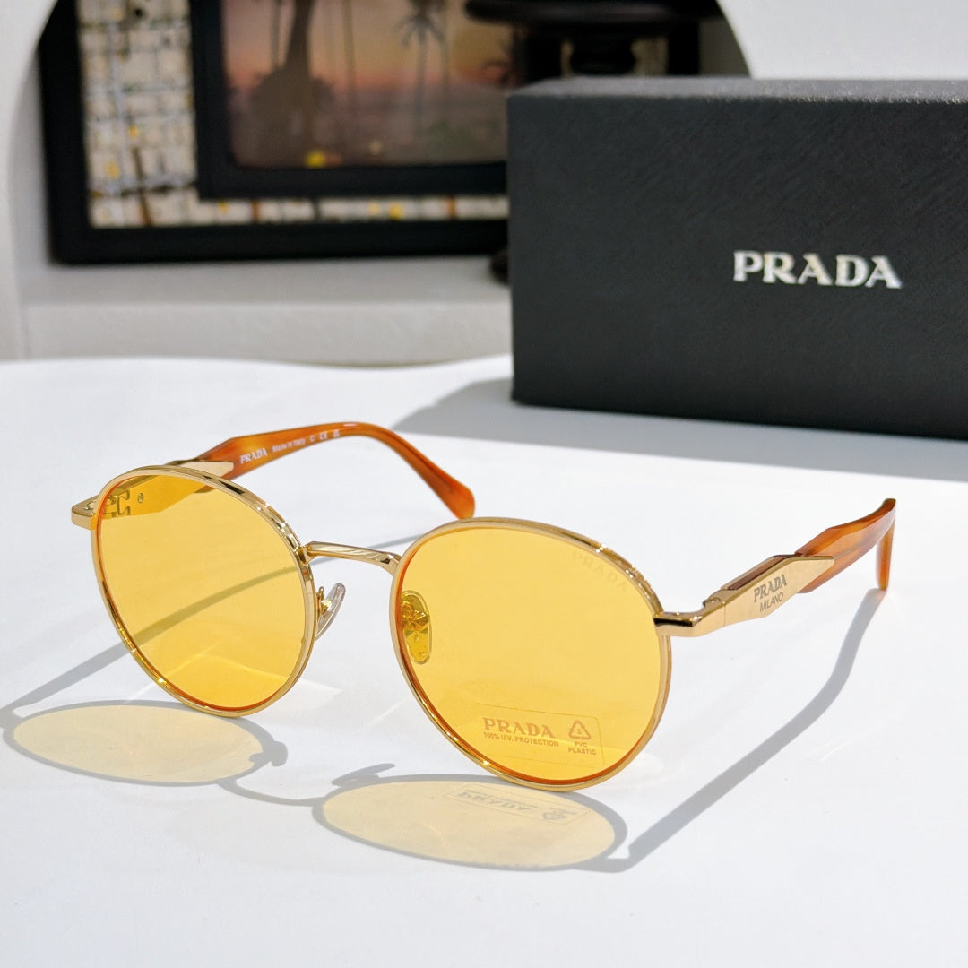 Prada sunglasses with gold metal round frames and yellow tinted lenses