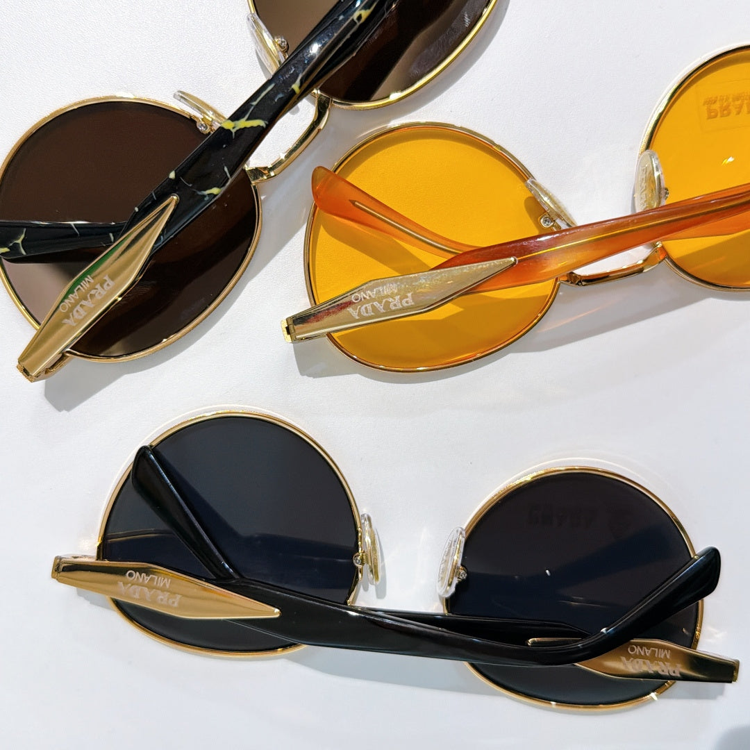 Prada sunglasses set with gold frames and orange, black, and brown tinted lenses