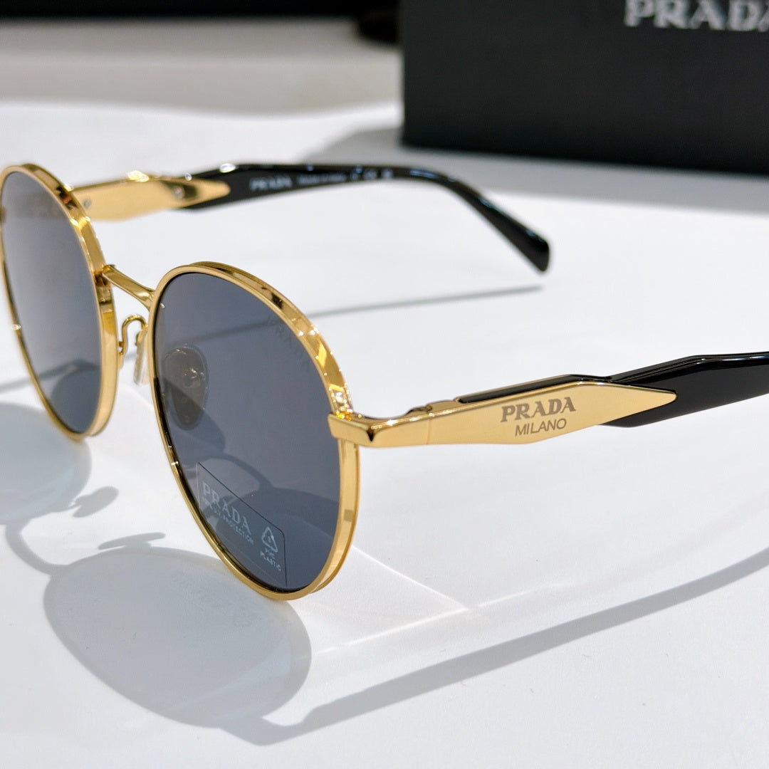 Prada sunglasses with gold metal round frames and blue tinted lenses, side view