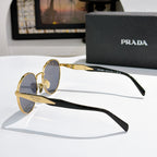Prada sunglasses with gold and black metal frames and blue tinted lenses