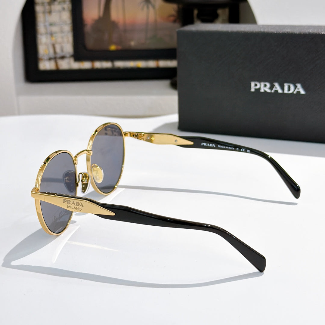 Prada sunglasses with gold and black metal frames and blue tinted lenses