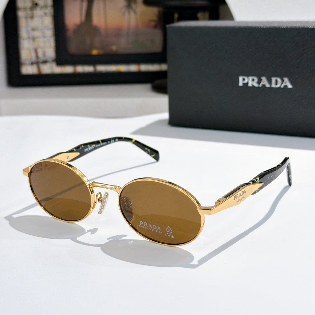 Prada round sunglasses with gold-tone frames and amber tinted lenses