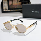 Prada round sunglasses with gold-tone frames and light tinted lenses