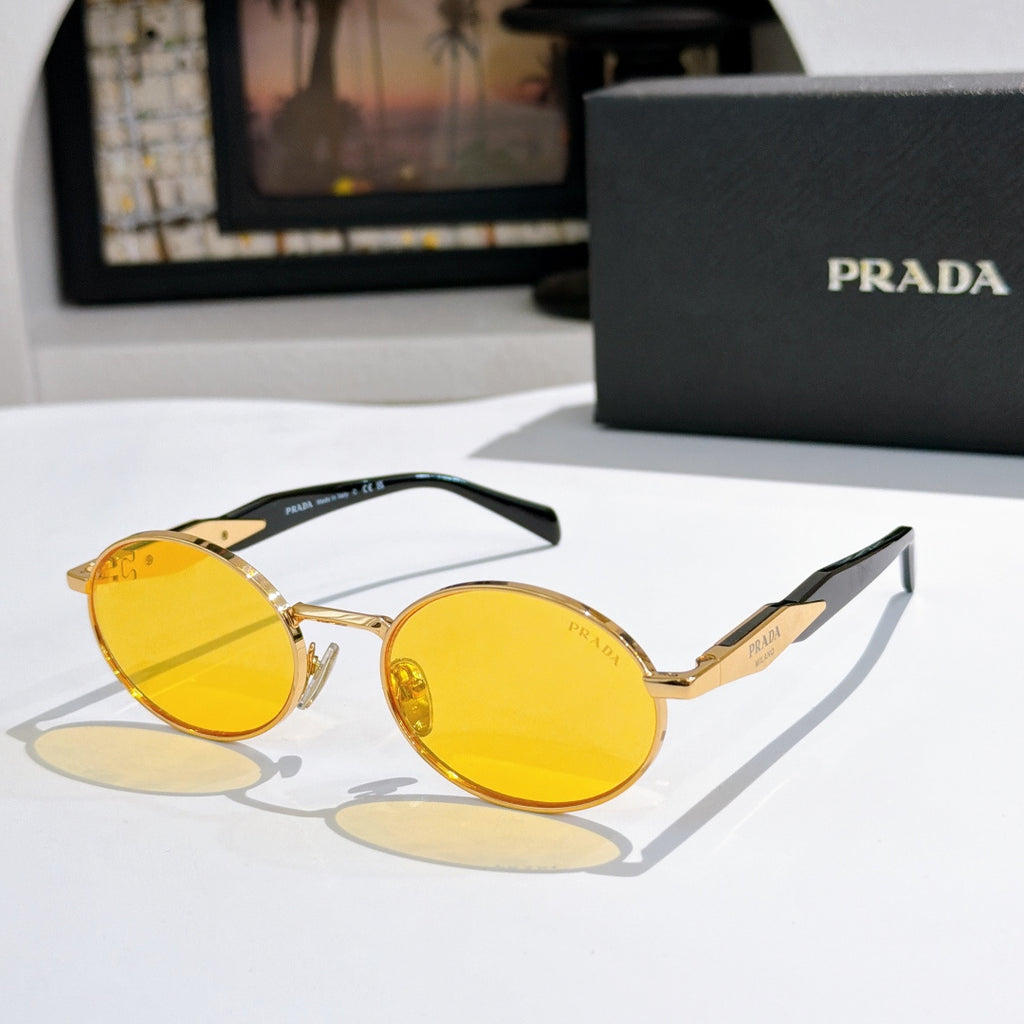 Prada round sunglasses with gold-tone frames and yellow tinted lenses