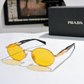 Prada round sunglasses with gold-tone frames and yellow tinted lenses