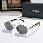 Prada round sunglasses with silver-tone frames and dark gray tinted lenses
