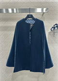 Navy long coat with stand collar and side snap closure, monogram-lined placket