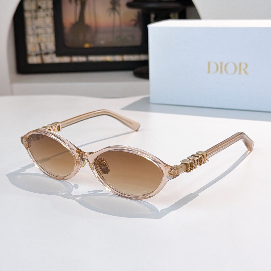 Sunglasses with clear light-pink frames, gold logo detail, tan lenses