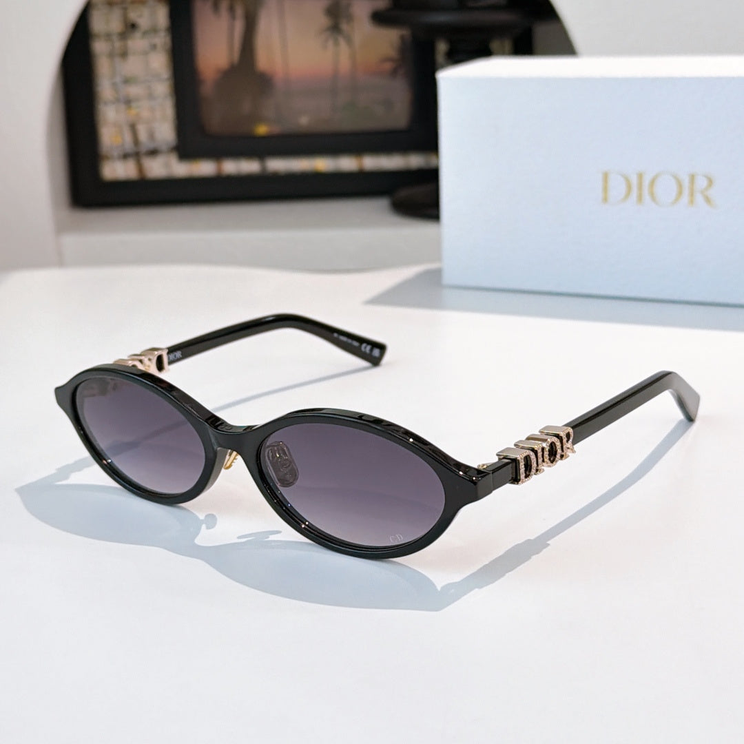 Sunglasses with black frames, gold logo detail, purple-tinted lenses