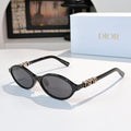 Dior sunglasses, black round frames with gold logos and gray lenses