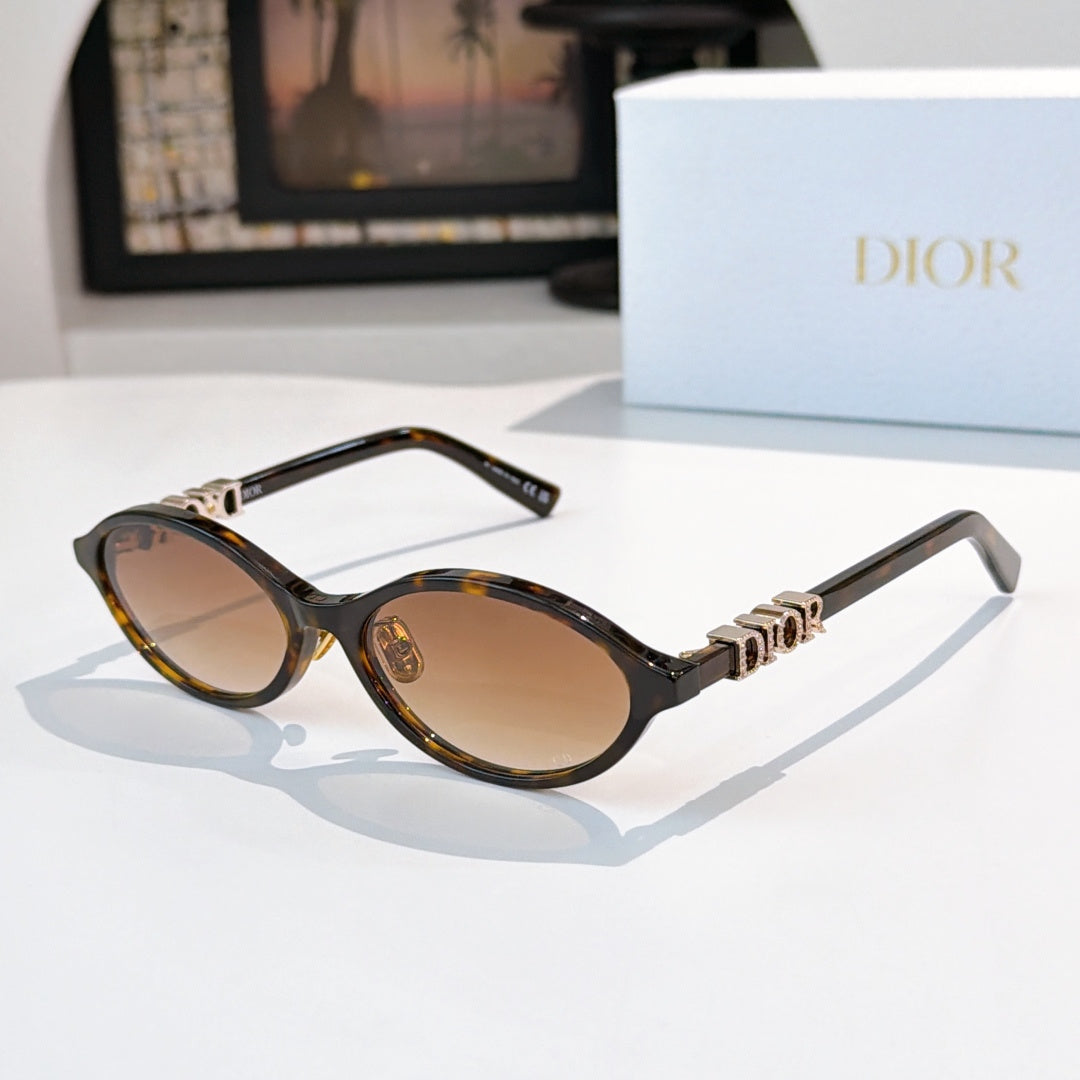 Sunglasses with tortoiseshell frames, gold logo detail, dark brown lenses