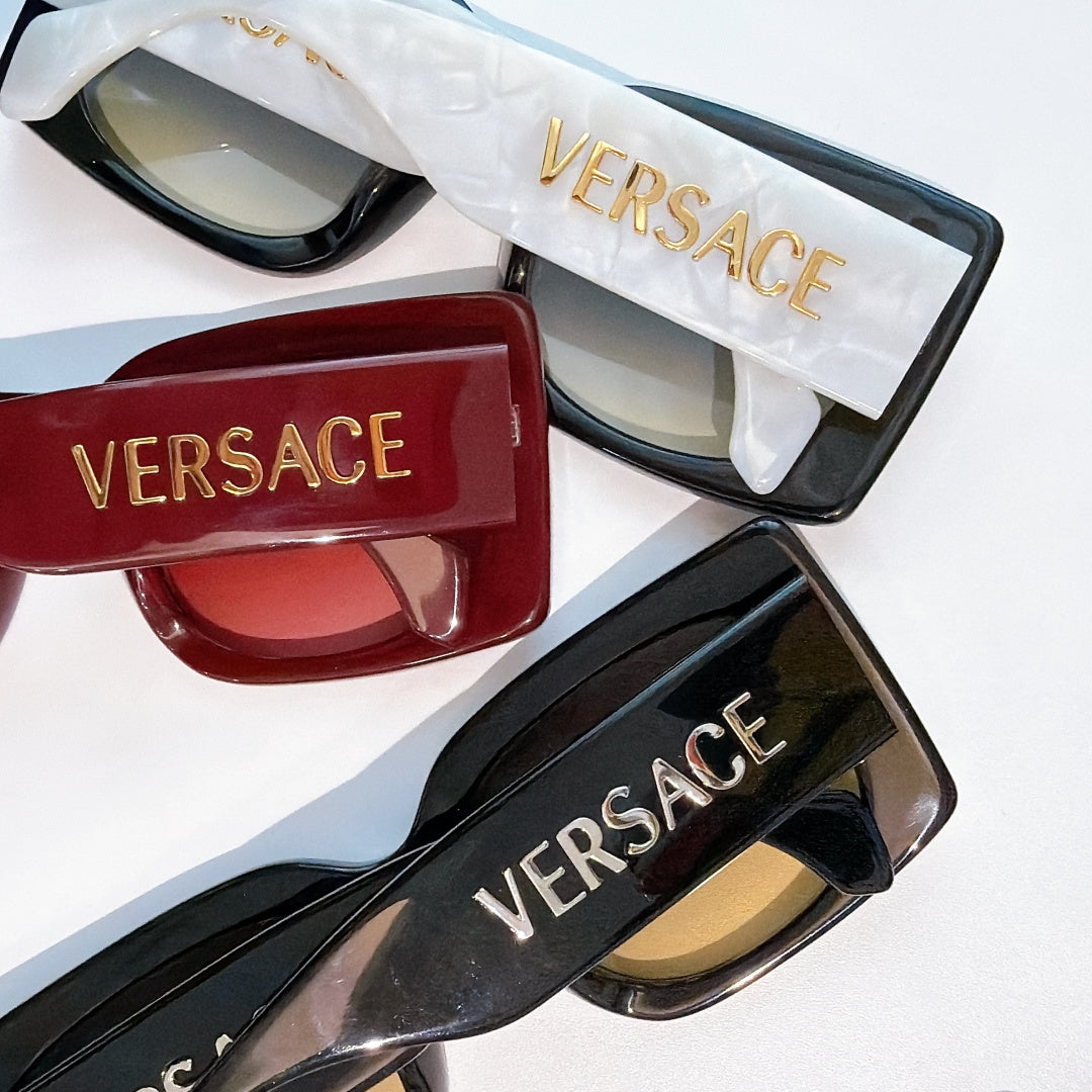 Versace sunglasses in black, red, and blue with VERSACE logo on temples