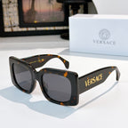 Versace sunglasses, dark tortoiseshell frames with tinted lenses and logo on temple