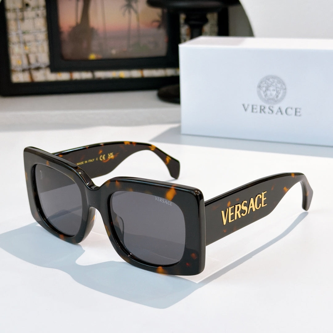 Versace sunglasses, dark tortoiseshell frames with tinted lenses and logo on temple