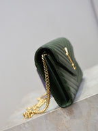 Green quilted leather clutch with gold-tone chain strap and curved flap edge, side view.