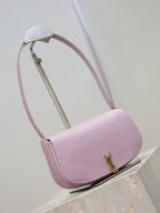 YSL small pink crossbody bag, angled view with long top handle and gold-tone logo