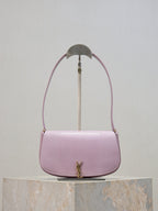 YSL small pink crossbody bag with curved flap, gold-tone logo clasp, textured finish