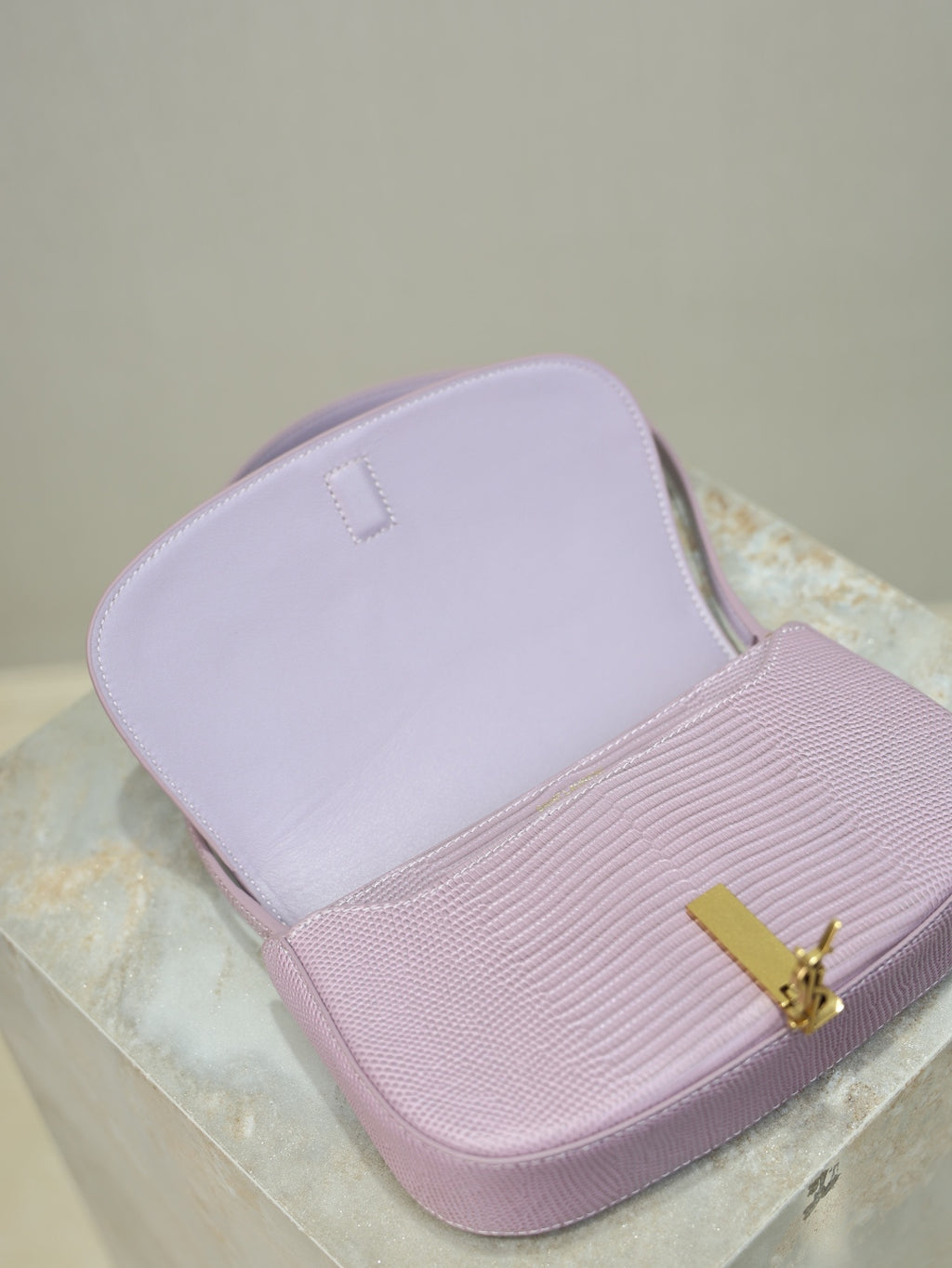 YSL small pink bag with open top showing interior lining and gold-tone logo clasp