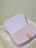 YSL small pink bag with open top showing interior lining and gold-tone logo clasp