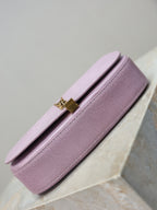 YSL small pink bag side profile with flap closure and gold-tone clasp hardware
