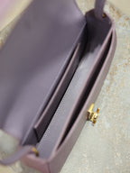 YSL small bag interior view with side wall and gold-tone logo clasp hardware