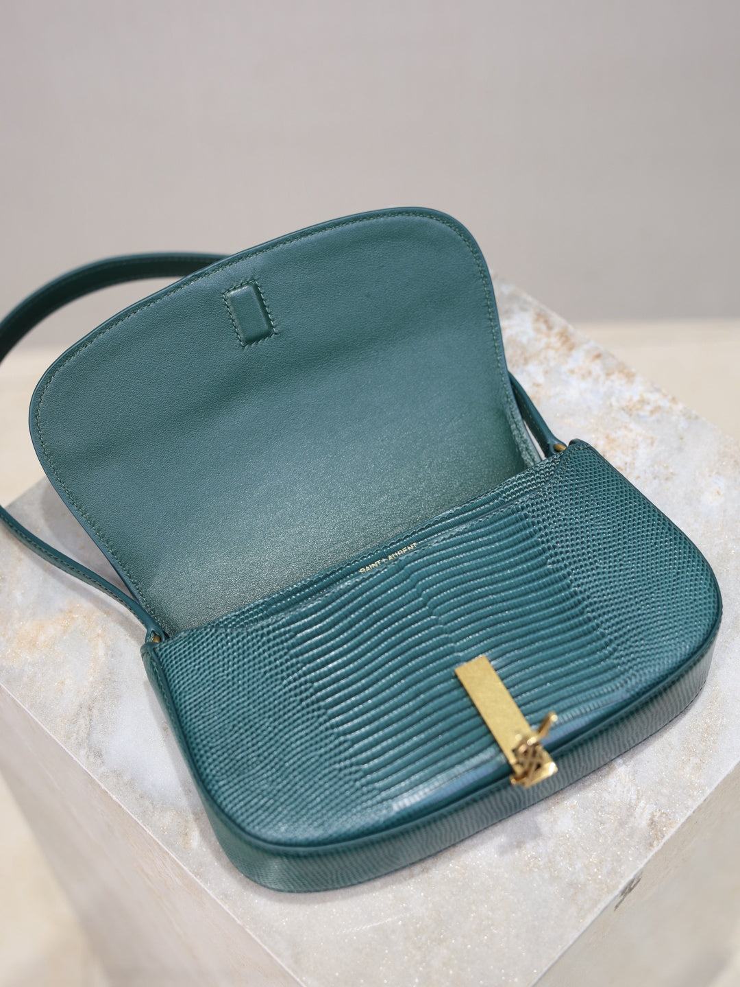 Teal leather handbag open top, textured flap front with gold YSL clasp