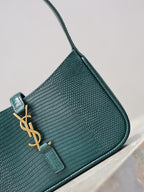 YSL small handbag front close-up, teal textured leather, gold YSL logo and snap tab.