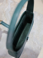YSL small handbag interior view, teal textured exterior, open top with slim clasp.
