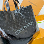 Men’s Louis Vuitton tote bag close-up with repeating monogram pattern and top handles.
