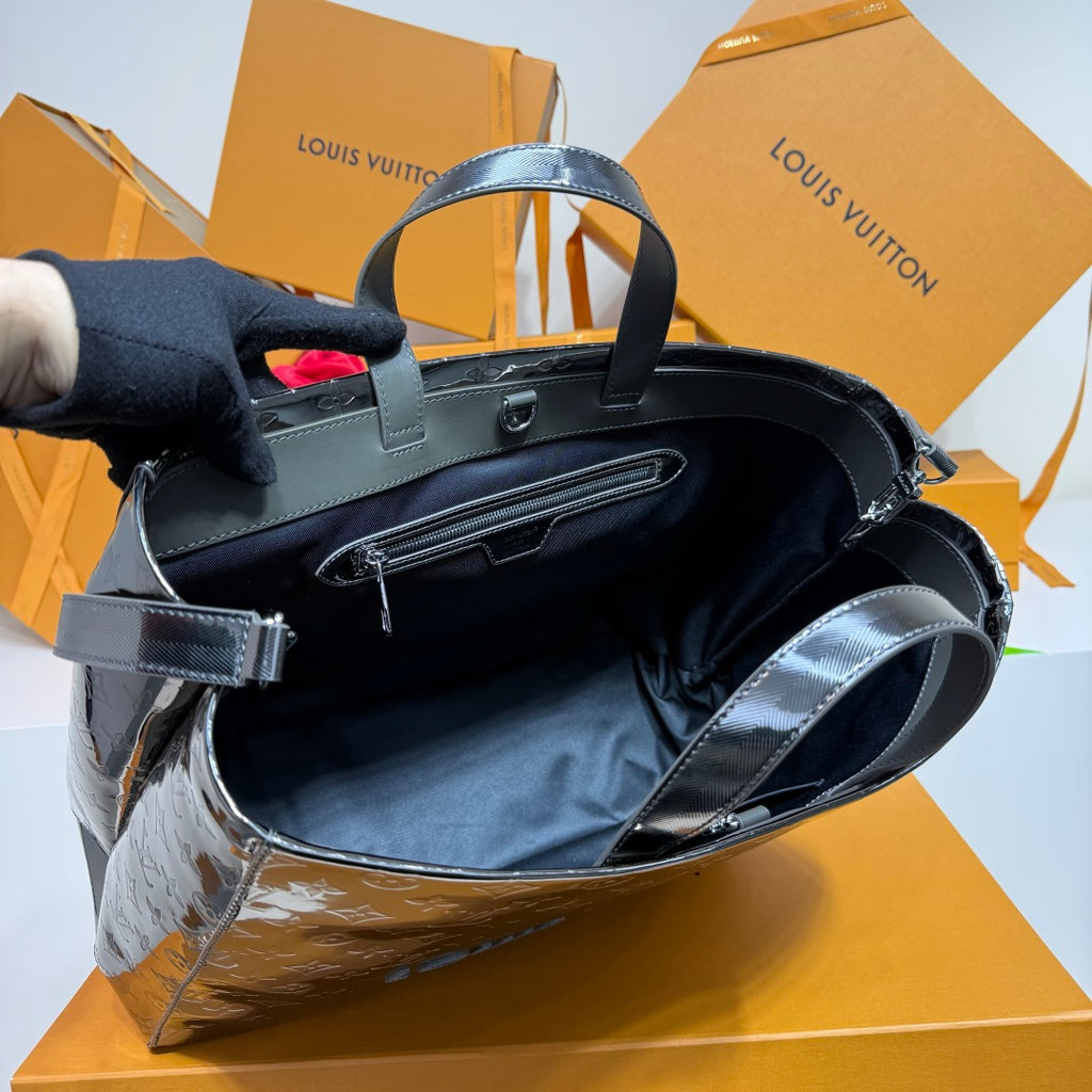 Men’s Louis Vuitton tote bag interior view with handles and shoulder strap, dark finish.