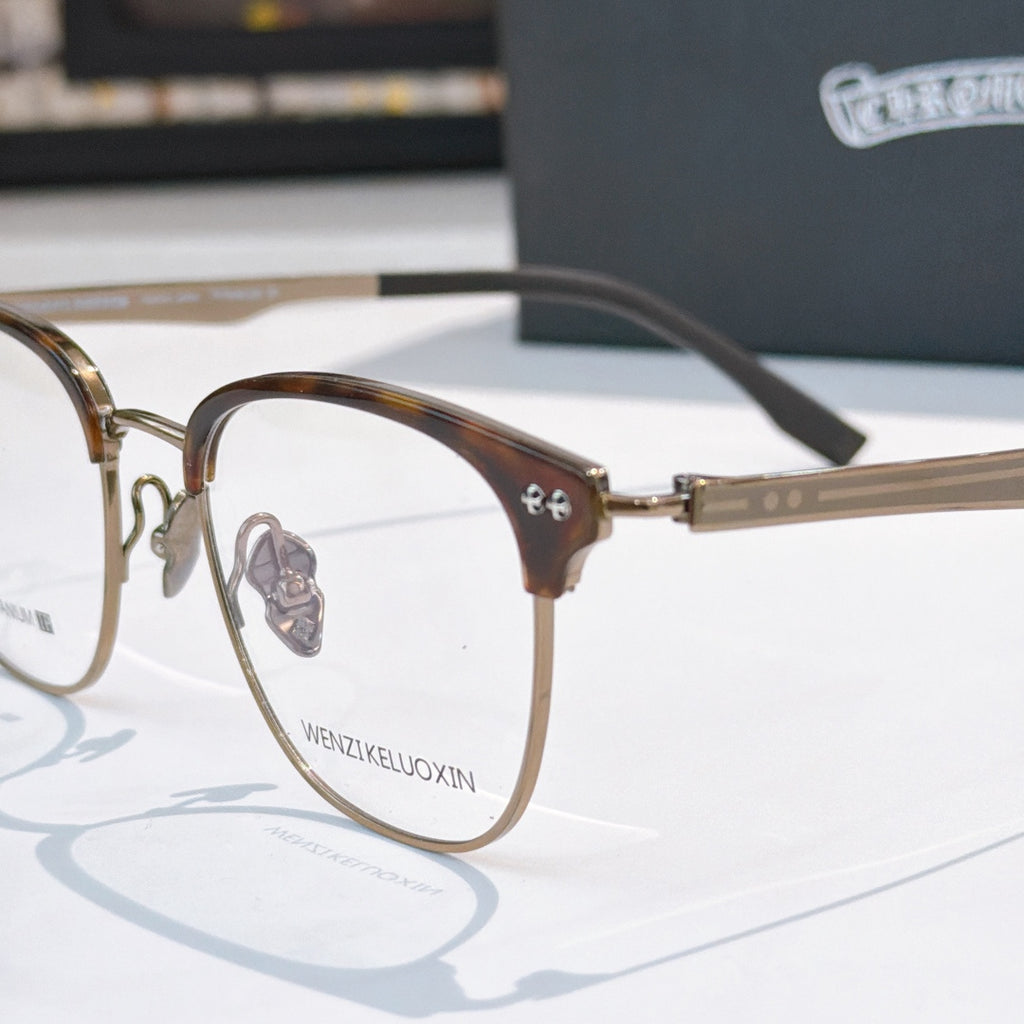 Brown eyeglass frames with clear lenses and metal bridge detail