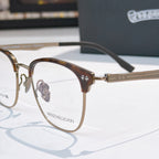 Brown eyeglass frames with clear lenses and metal bridge detail