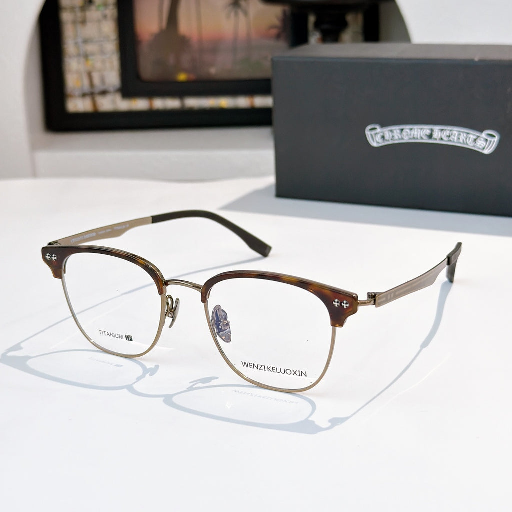 Dark brown metal eyeglass frames with clear lenses and black temple tips