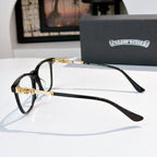 Black full-rim eyeglasses with gold-tone temples and clear lenses, side view