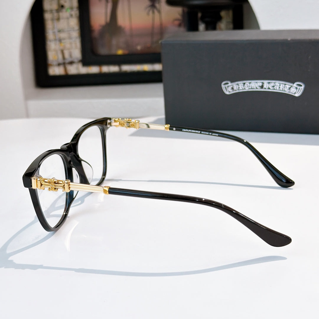 Black full-rim eyeglasses with gold-tone temples and clear lenses, side view