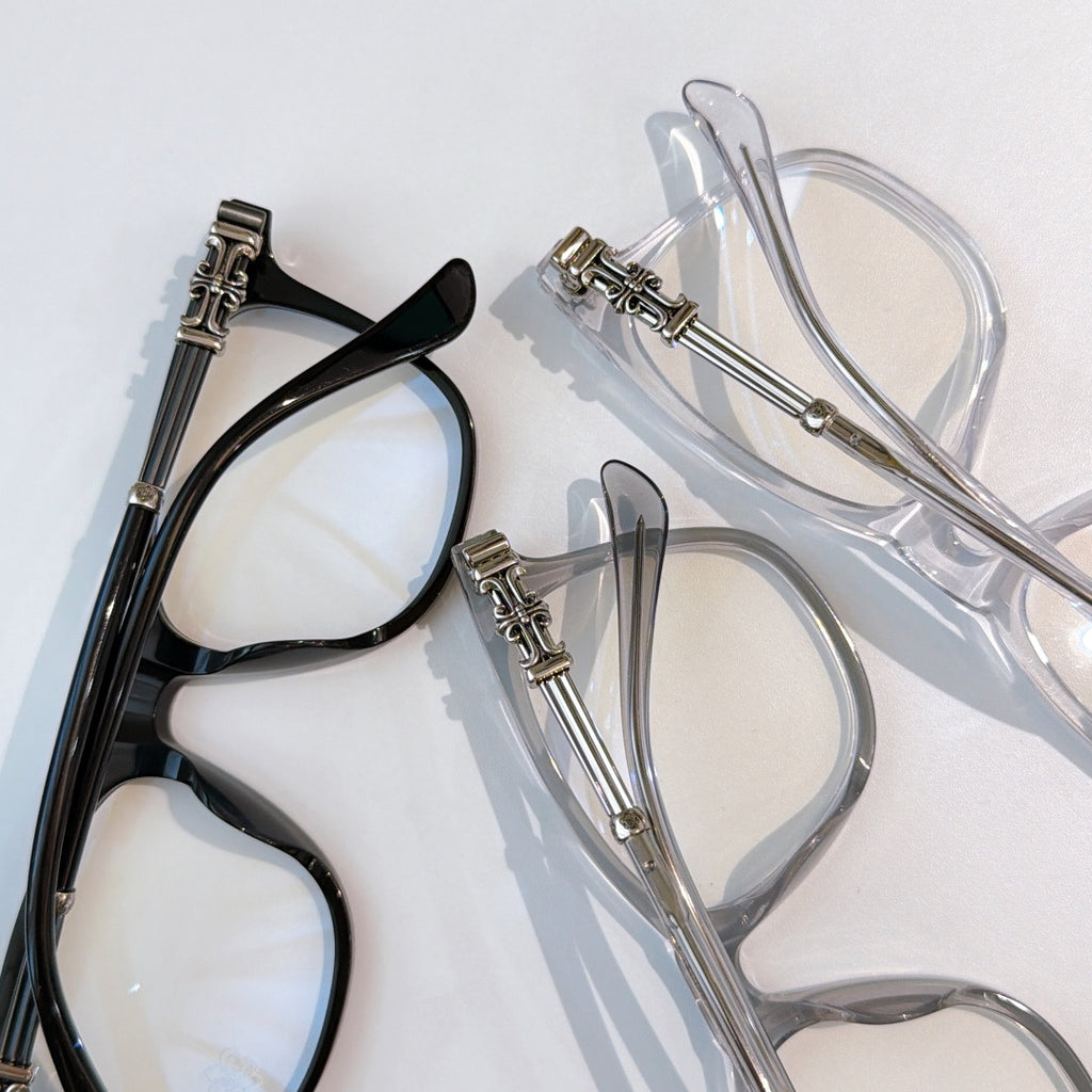 Pair of eyeglasses: black frame and transparent frame with silver-tone hinges