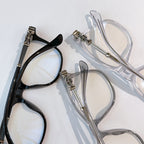 Pair of eyeglasses: black frame and transparent frame with silver-tone hinges