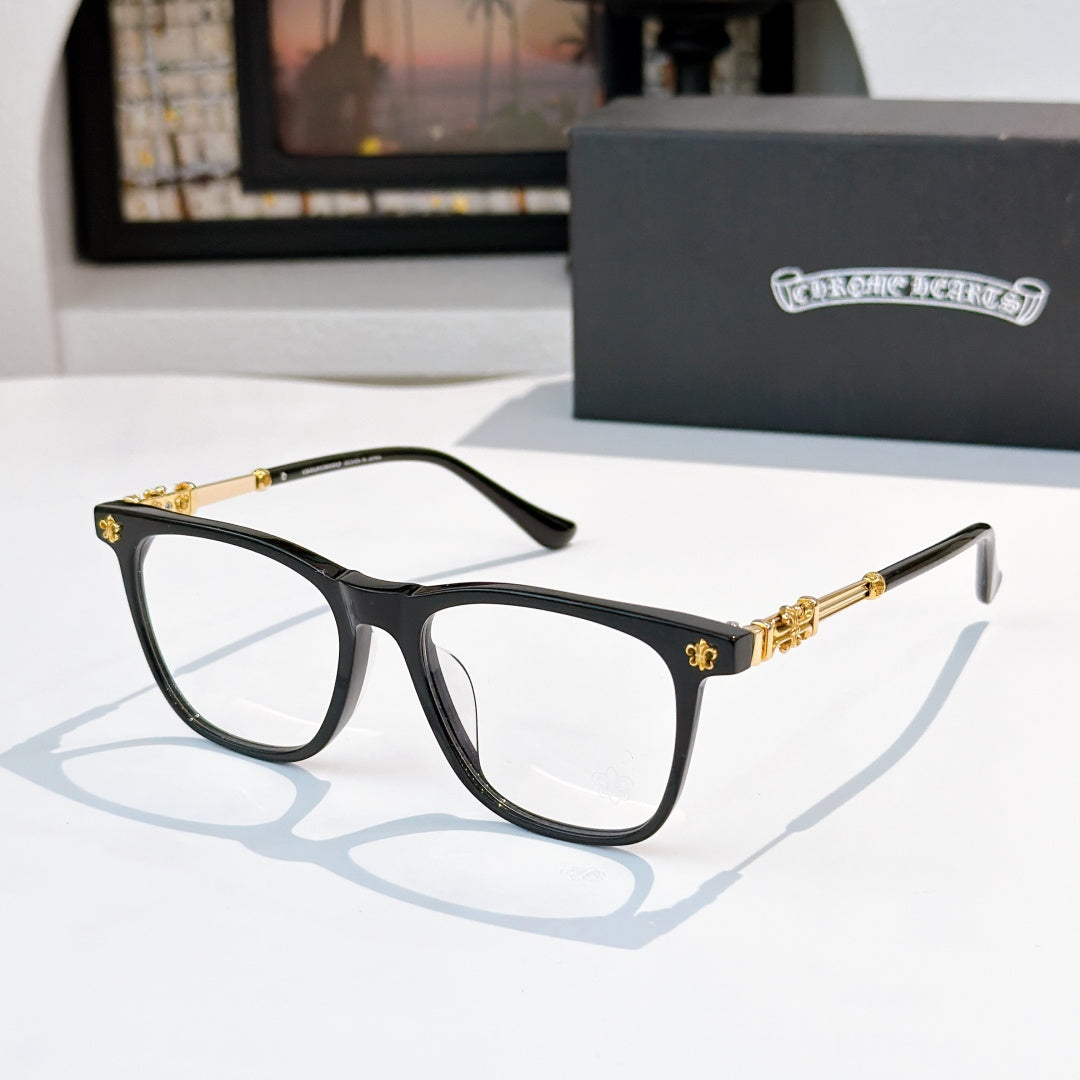 Black full-rim eyeglasses with clear lenses and gold-tone temples